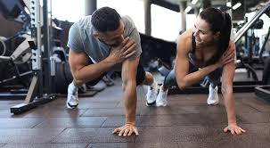 Sculpting Sleek Arms: The Essential Role of Cardio in Toning Without Bulking Up 1 Image of man and woman doing Cardio Surrey to tone their arms.